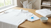 Blue paint and texta stains on a white school uniform polo shirt